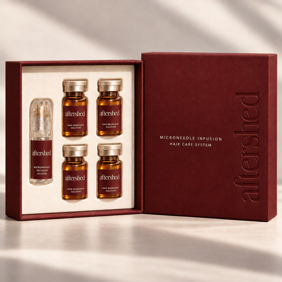 The AfterShed one-month kit: a press stamp and four serum vials in a burgundy box